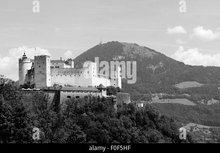 Hohensalzburg Castle atop the Festungsberg with the Gaisberg mountain beyond on a summer day in Salzburg, Austria Stock Photo