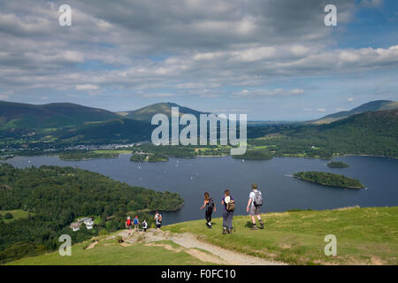 Trekkers take in the view of Derwentwater from Catbells fell near Keswick in the Lake District Stock Photo