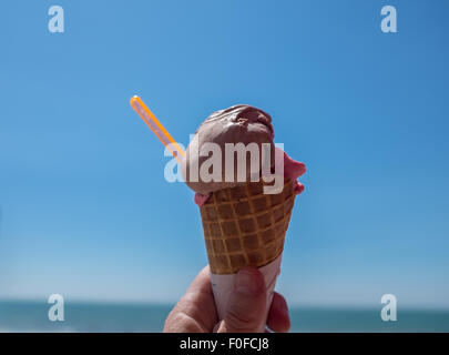 Ice cream cone against a bright clear blue summer sky Stock Photo