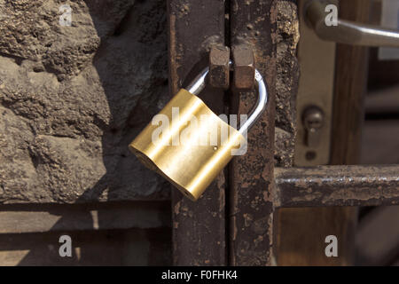 New lock on old rusty bars. Stock Photo