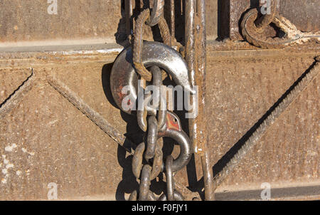Hook and chain on rusty metal. Stock Photo