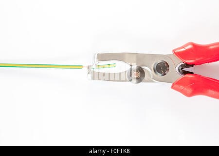 small nippers with black red handles on wooden board Stock Photo