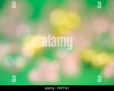 The pink and gold bokeh effect on the green background. Stock Photo