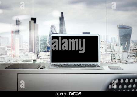 Laptop with blank screen on white desk with blurred background as concept Stock Photo