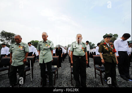 Chinese veterans stand in silent tribute during the opening ceremony of a museum about Japanese army Unit 731 wartime atrocities in Harbin, capital of northeast China's Heilongjiang Province, Aug. 15, 2015. The Museum of Evidence of War Crimes by Japanese Army Unit 731, located on the site of former headquarters of Japanese army unit 731 in Harbin, opened on Saturday. Unit 731 was a biological and chemical warfare research base established in 1935. Stock Photo