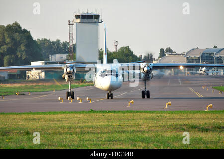 Propeller passenger plane taxiing to the runway in the airport front view Stock Photo