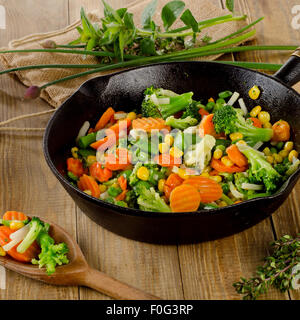 Stir fried vegetables in  iron skillet . Selective focus Stock Photo