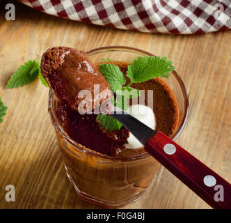 Chocolate Mousse in a spoon on   a wooden table. Selective focus Stock Photo