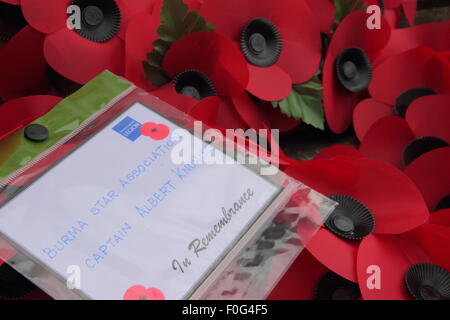 Hayfield, High Peak, Derbyshire, UK. 15 Aug, 2015.WWII veteran and President of Hayfield Royal British Legion Albert Knowles (l) lays down a ‘Burma Star Association' wreath with his son, George Knowles (r), 72, at Hayfield War Memorial during a thanksgiving service to mark the 70th anniversary of victory over Japan. Albert will celebrate his 100th birthday on 25th AUG, 2015. Captain Knowles served in Burma, Malaya, India and Singapore. He became President of the Hayfield Branch in 1950 and is believed to be the longest serving Branch President in the UK. Credit:  Deborah Vernon/Alamy Live News Stock Photo