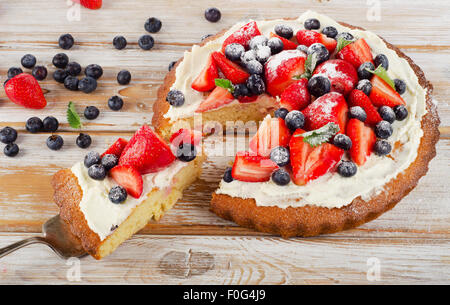 Fresh berry  cake on   white   wooden background. Stock Photo