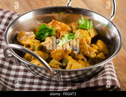 Chicken curry in  balti dish on  wooden table. Selective focus Stock Photo