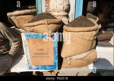 Amritsar, Punjab, India. Tea seller on the street near the Golden Temple; tea in jute sacks on top of traditional tea chests marked 'Wholesale Package Produce of India'. Stock Photo