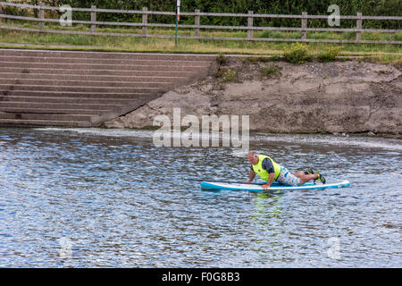 A man Giving paddle boarding lessons to a group of people at Chasewater Country Park lichfield, Staffordshire, UK Stock Photo