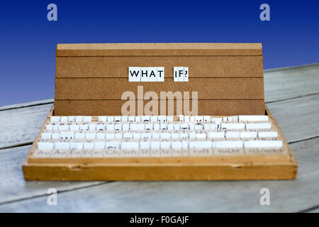 the word "what if?" on an old school letter box on a blue background Stock Photo