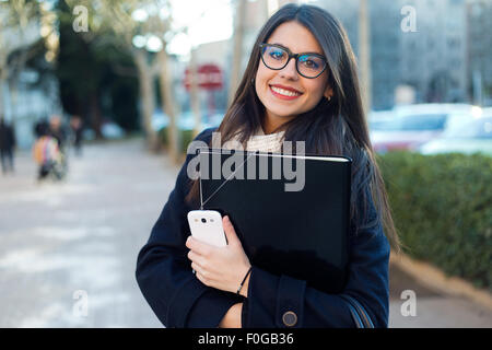 Outdoor portrait of young beautiful woman looking at camera. Stock Photo