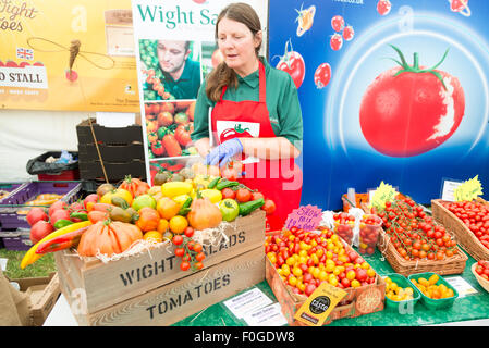 Newchurch, Isle of Wight, UK. 15th Aug, 2015. Donna Bennett from Wight Salads sells locally grown tomatoes at the festival, the Island’s biggest summer food fair and entertainment event. The festival celebrates the famous garlic grown on the Island and other local foods, crafts, music and family entertainment. Credit: Julian Eales/Alamy Live News Stock Photo