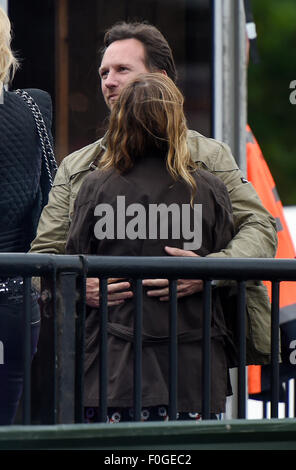 Geri Halliwell cuddles up to new husband Christian Horner at the Isle of Wight Festival as they watch the main stage. Former band-mate, Mel C was also with them briefly.  Featuring: Geri Halliwell, Christian Horner Where: Isle Of Wight, United Kingdom When: 14 Jun 2015 Stock Photo