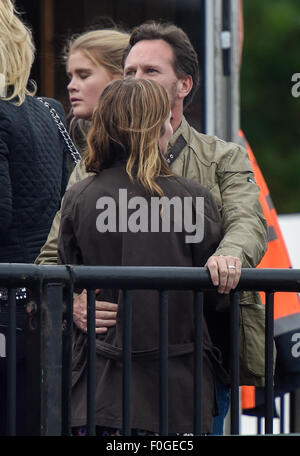 Geri Halliwell cuddles up to new husband Christian Horner at the Isle of Wight Festival as they watch the main stage. Former band-mate, Mel C was also with them briefly.  Featuring: Geri Halliwell, Christian Horner Where: Isle Of Wight, United Kingdom When: 14 Jun 2015 Stock Photo