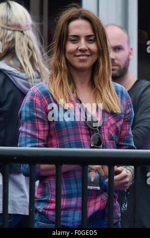 Geri Halliwell cuddles up to new husband Christian Horner at the Isle of Wight Festival as they watch the main stage. Former band-mate, Mel C was also with them briefly.  Featuring: Mel C Where: Isle Of Wight, United Kingdom When: 14 Jun 2015 Stock Photo