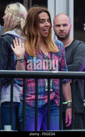 Geri Halliwell cuddles up to new husband Christian Horner at the Isle of Wight Festival as they watch the main stage. Former band-mate, Mel C was also with them briefly.  Featuring: Mel C Where: Isle Of Wight, United Kingdom When: 14 Jun 2015 Stock Photo