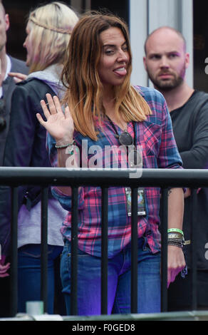 Geri Halliwell cuddles up to new husband Christian Horner at the Isle of Wight Festival as they watch the main stage. Former band-mate, Mel C was also with them briefly.  Featuring: Mel C Where: Isle Of Wight, United Kingdom When: 14 Jun 2015 Stock Photo