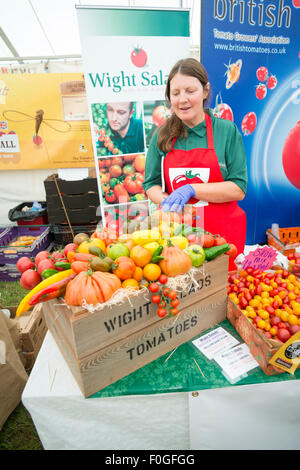 Newchurch, Isle of Wight, UK. 15th Aug, 2015. Donna Bennett from Wight Salads sells locally grown tomatoes at the festival, the Island’s biggest summer food fair and entertainment event. The festival celebrates the famous garlic grown on the Island and other local foods, crafts, music and family entertainment. Credit: Julian Eales/Alamy Live News Stock Photo