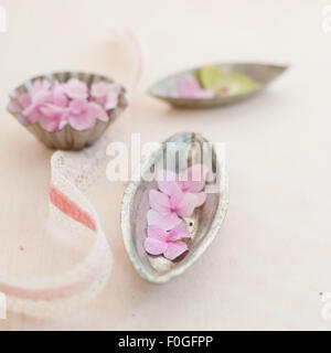 pink hydrangeas, vintage baking tins and ribbon Stock Photo