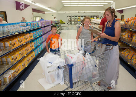 Salt Lake City, Utah - The Relief Society president of a Mormon ward (congregation) picks up groceries for a needy member. Stock Photo