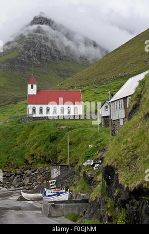 Church and boats, village of Kunoy, Kunoy Island, Faroe Islands Stock Photo