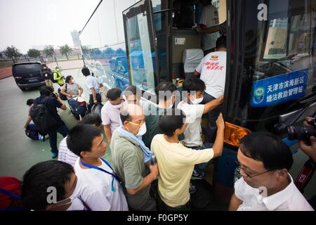 China. 15th Aug, 2015. Refugees boarding the bus to evacuat from the temporary refugees camp as local authority confirmed there are toxic gas in the surrounding area of the blast. The death toll has risen to 104. Local authority starts to evacuate local residents from the temporary camp located at a local school near the blast zone as they extend the exclusion zone to 3 km from where the explosion happened as poison air which could cause cancer is being detected. © Geovien So/Pacific Press/Alamy Live News Stock Photo