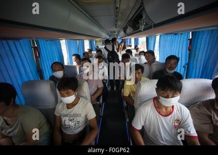 China. 15th Aug, 2015. Refugees seen wearing face masks in order to protect themselves from the toxic air which has been confirmed by the Chinese authority as they were being evacuated. The death toll has risen to 104. Local authority starts to evacuate local residents from the temporary camp located at a local school near the blast zone as they extend the exclusion zone to 3 km from where the explosion happened as poison air which could cause cancer is being detected. © Geovien So/Pacific Press/Alamy Live News Stock Photo