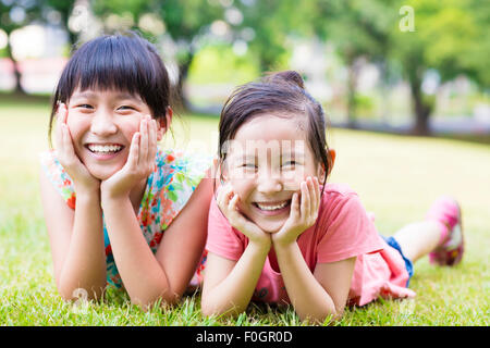 closeup happy little girls on the grass Stock Photo