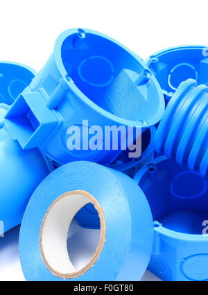 Heap of blue electrical boxes and components for use in electrical installations, accessories for engineering jobs Stock Photo