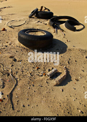 Litter and Rubber Pollution on our Coastal Beach Environmental Problem Stock Photo