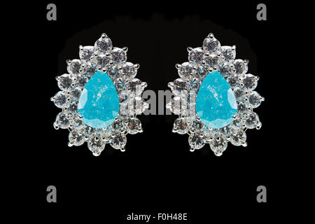 earrings with blue stones on the black Stock Photo