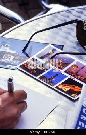 Writing a postcard from Blackpool. Lancashire. UK Stock Photo