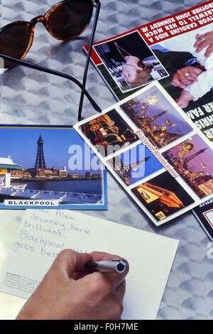 Writing a postcard from Blackpool. Lancashire. UK Stock Photo