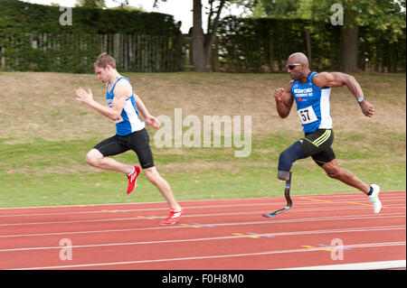Sport for all 100m male sprint hundred meters race running at high speed athletes sprinters competing on track and field event Stock Photo