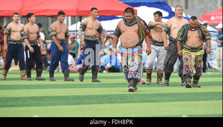 (150816) -- ORDOS, Aug 16, 2015 (Xinhua) -- Wrestlers walk into the arena for men's individual event of the Mongolian wrestling, or 'Boke' in Chinese, during the 10th National Traditional Games of Ethnic Minorities of China in Ordos, north China's Inner Mongolia Autonomous Region, Aug. 16, 2015. Boke, with the meaning of 'strong and healthy' in the Mongolian language, is a historic sport practiced by the Mongolian people and is popular among normadic people in northern China. The wrestlers, usually armored with leather jackets dotted by silver buttons, hold each others' arms and try every mean Stock Photo