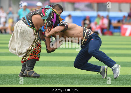 (150816) -- ORDOS, Aug 16, 2015 (Xinhua) -- A Mongolian wrestler (L) and a Tibetan wrestler compete in men's individual event of the Mongolian wrestling, or 'Boke' in Chinese, during the 10th National Traditional Games of Ethnic Minorities of China in Ordos, north China's Inner Mongolia Autonomous Region, Aug. 16, 2015. Boke, with the meaning of 'strong and healthy' in the Mongolian language, is a historic sport practiced by the Mongolian people and is popular among normadic people in northern China. The wrestlers, usually armored with leather jackets dotted by silver buttons, hold each others Stock Photo