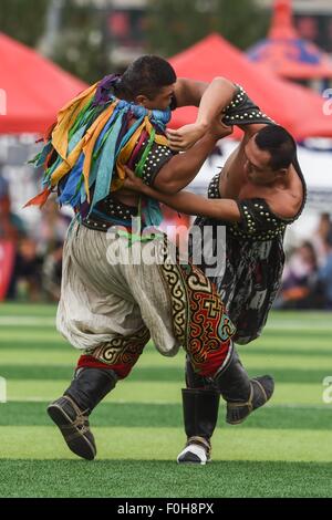 (150816) -- ORDOS, Aug 16, 2015 (Xinhua) -- Two Mongolian wrestlers compete in men's individual event of the Mongolian wrestling, or 'Boke' in Chinese, during the 10th National Traditional Games of Ethnic Minorities of China in Ordos, north China's Inner Mongolia Autonomous Region, Aug. 16, 2015. Boke, with the meaning of 'strong and healthy' in the Mongolian language, is a historic sport practiced by the Mongolian people and is popular among normadic people in northern China. The wrestlers, usually armored with leather jackets dotted by silver buttons, hold each others' arms and try every mea Stock Photo