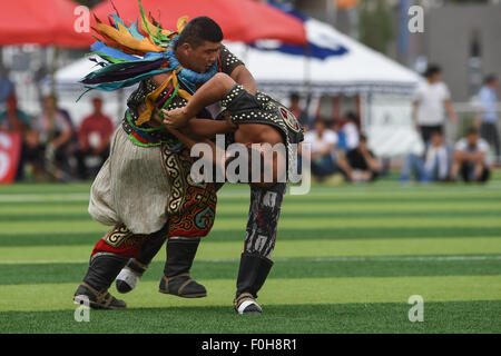 (150816) -- ORDOS, Aug 16, 2015 (Xinhua) -- Two Mongolian wrestlers compete in men's individual event of the Mongolian wrestling, or 'Boke' in Chinese, during the 10th National Traditional Games of Ethnic Minorities of China in Ordos, north China's Inner Mongolia Autonomous Region, Aug. 16, 2015. Boke, with the meaning of 'strong and healthy' in the Mongolian language, is a historic sport practiced by the Mongolian people and is popular among normadic people in northern China. The wrestlers, usually armored with leather jackets dotted by silver buttons, hold each others' arms and try every mea Stock Photo