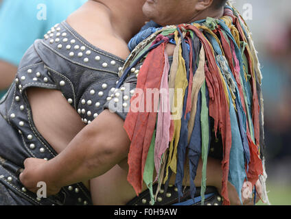 (150816) -- ORDOS, Aug 16, 2015 (Xinhua) -- A Mongolian wrestler wearing jangga, an honor symbol for Mongolian wrestlers, competes with another wrestler in men's individual event of the Mongolian wrestling, or 'Boke' in Chinese, during the 10th National Traditional Games of Ethnic Minorities of China in Ordos, north China's Inner Mongolia Autonomous Region, Aug. 16, 2015. Boke, with the meaning of 'strong and healthy' in the Mongolian language, is a historic sport practiced by the Mongolian people and is popular among normadic people in northern China. (Xinhua/Wu Wei) Stock Photo