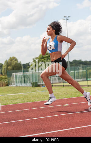 Sport for all female sprint 400m meters race running at high speed athletes sprinters competing on track and field event winning Stock Photo