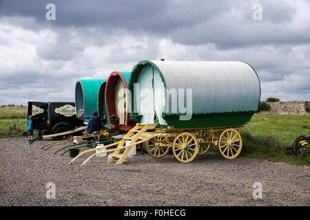 Bow top caravans temporarily camped in the car park at Boulmer in Northumberland Stock Photo