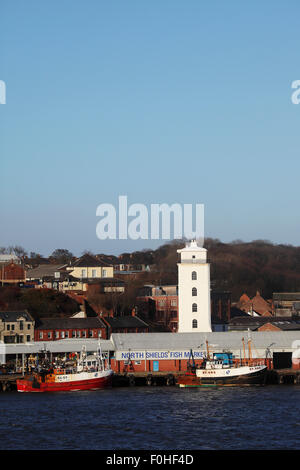 The fish market be the harbour in North Shields, England. The Low Light tower stands by the dock. Stock Photo