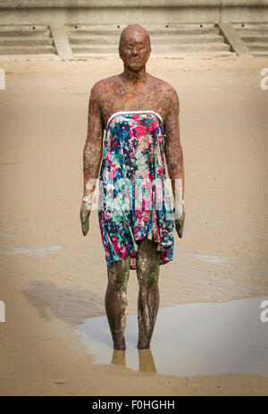 Antony Gormleys Another Place Sculpture on Crosby Beach wearing a dress Stock Photo