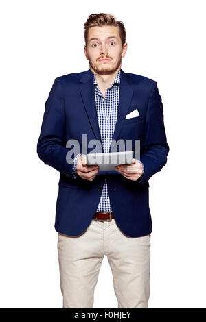 Studio shot of surprised young man using digital tablet. Isolated on white. Stock Photo
