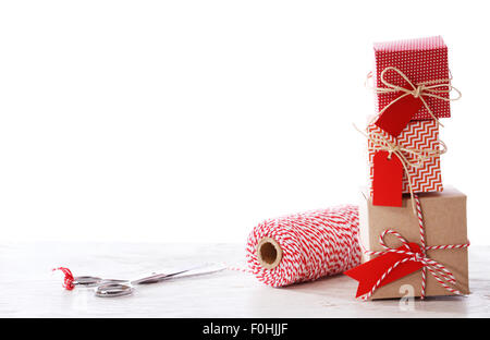 Handmade small boxes with scissors and spool on white background Stock Photo