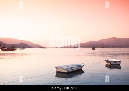 two small boats tied with rope at Aegean sea bay Stock Photo